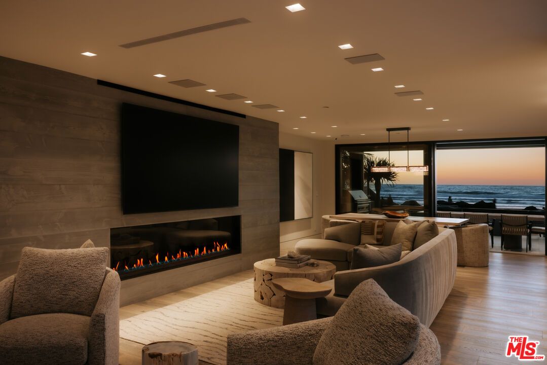 Dining room, Fireplace, Interior, Living room, Pendant Lights, Recessed Lighting, Water, Wood Texture Flooring, Wooden Walls